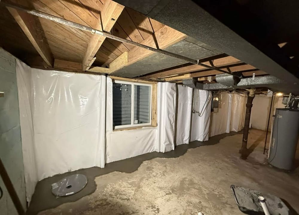 Waterproofed basement with vapor-barrier walls and a dry floor